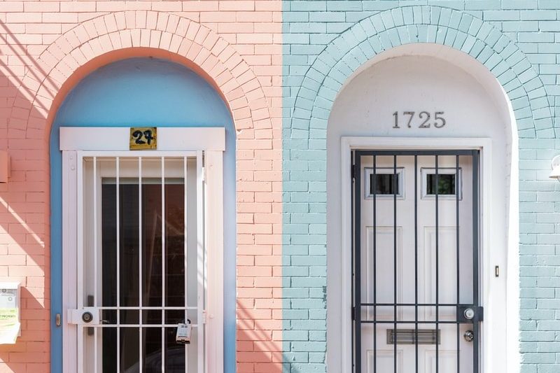 two white wooden doors with grills
